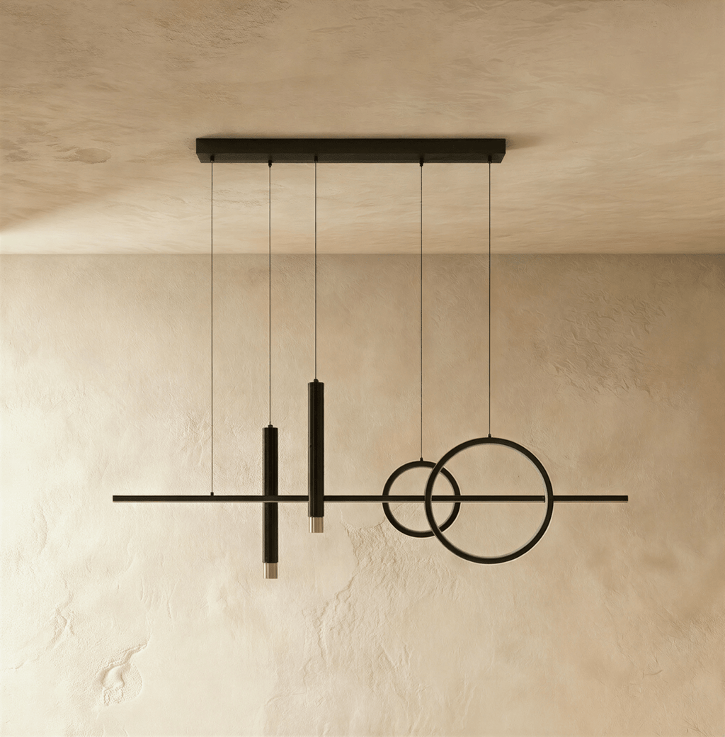 Clérachic matte black pendant light with a bar, two overlapping rings and two spot cylinders, unlit, on a limewash wall.