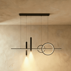 Clérachic black pendant light with a slim bar, two overlapping rings and two lit spot cylinders on a limewash wall.