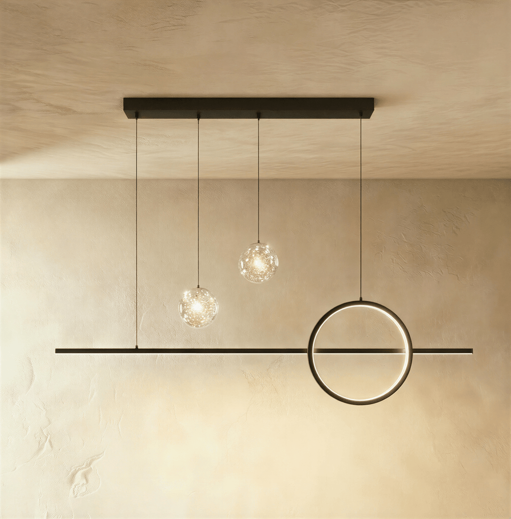 Clérachic black ring and bar pendant light with two clear glass globes holding tiny sparkling lights, on limewash.