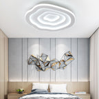 The Clérachic Ripple Spiral ceiling light above a bedroom, layered rings echoing the wall artwork.
