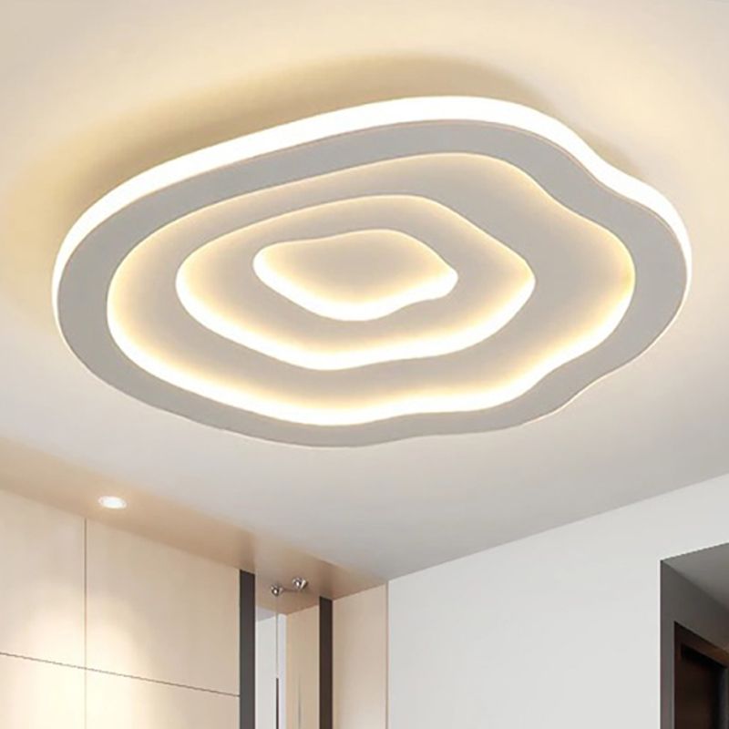 Close ceiling view of the Clérachic Ripple Spiral, warm light pooling in the innermost acrylic ring.