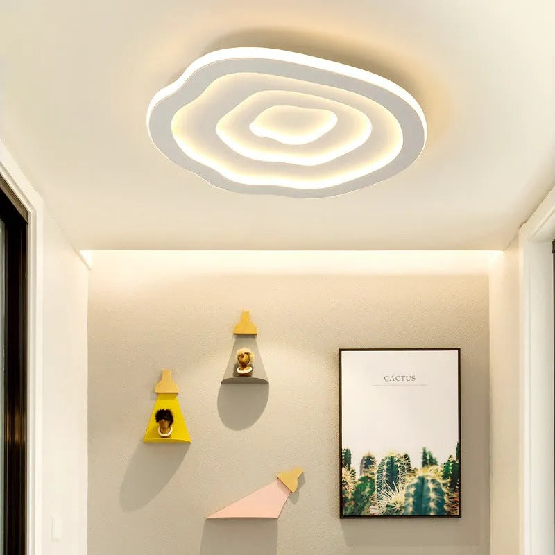 Clérachic Ripple Spiral flush mount in a bright hallway hung with framed art and small shelf decor.
