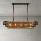 This Clérachic chandelier in smoke-brown glass hangs from a black long canopy on a black chain, lit on a grey backdrop.