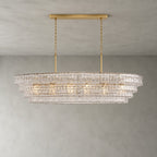 Clear rippled glass on this Clérachic chandelier, with a gold long canopy bar and four stepped tiers, lit on grey.