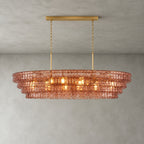 A four-tier rose-pink Clérachic chandelier hung from a gold long canopy bar, its bulbs glowing through the glass.