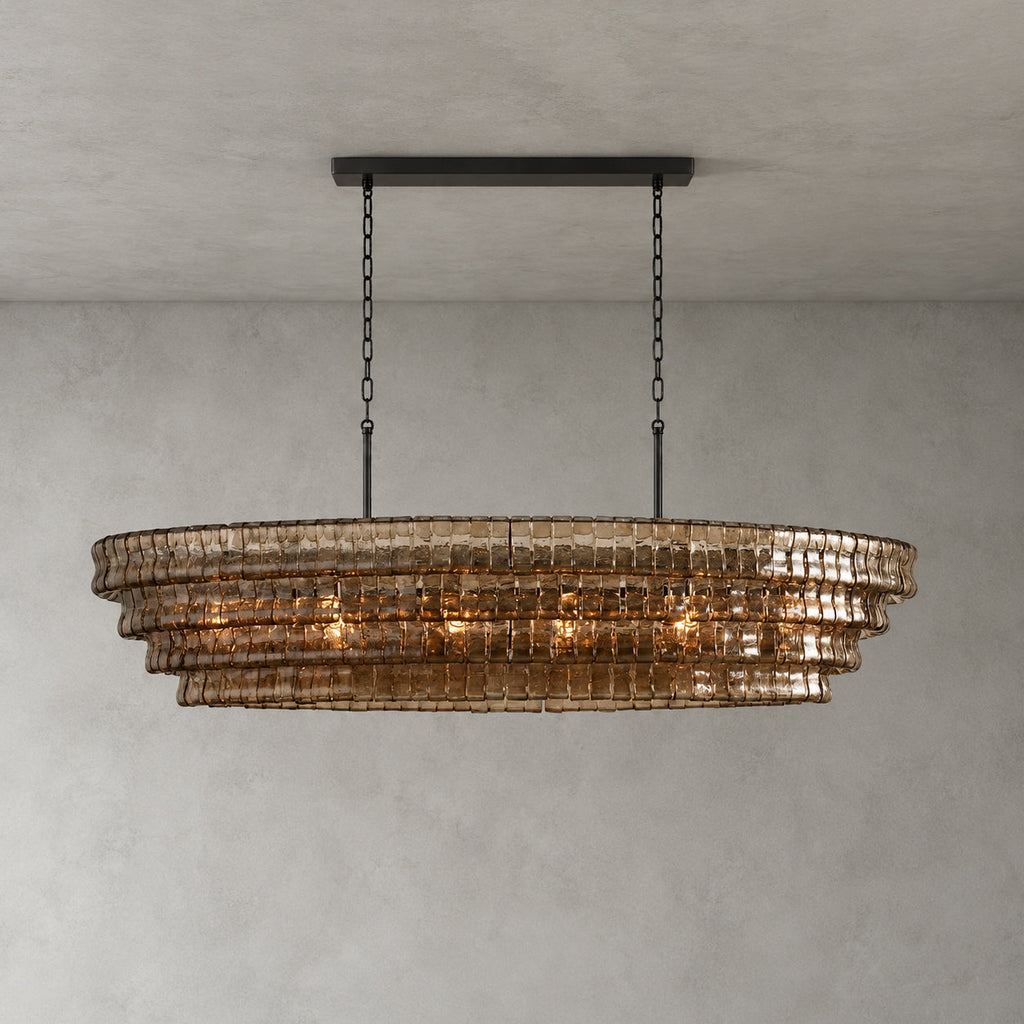 Smoke-grey glass tiers of this Clérachic chandelier hang from a black long canopy bar on black chains, lit on grey.