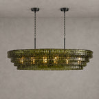 This Clérachic chandelier in green glass hangs from two black round canopies, its four tiers lit against grey.