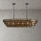 Smoke-grey glass on this four-tier Clérachic chandelier, hung from two black round canopies and black chains on grey.