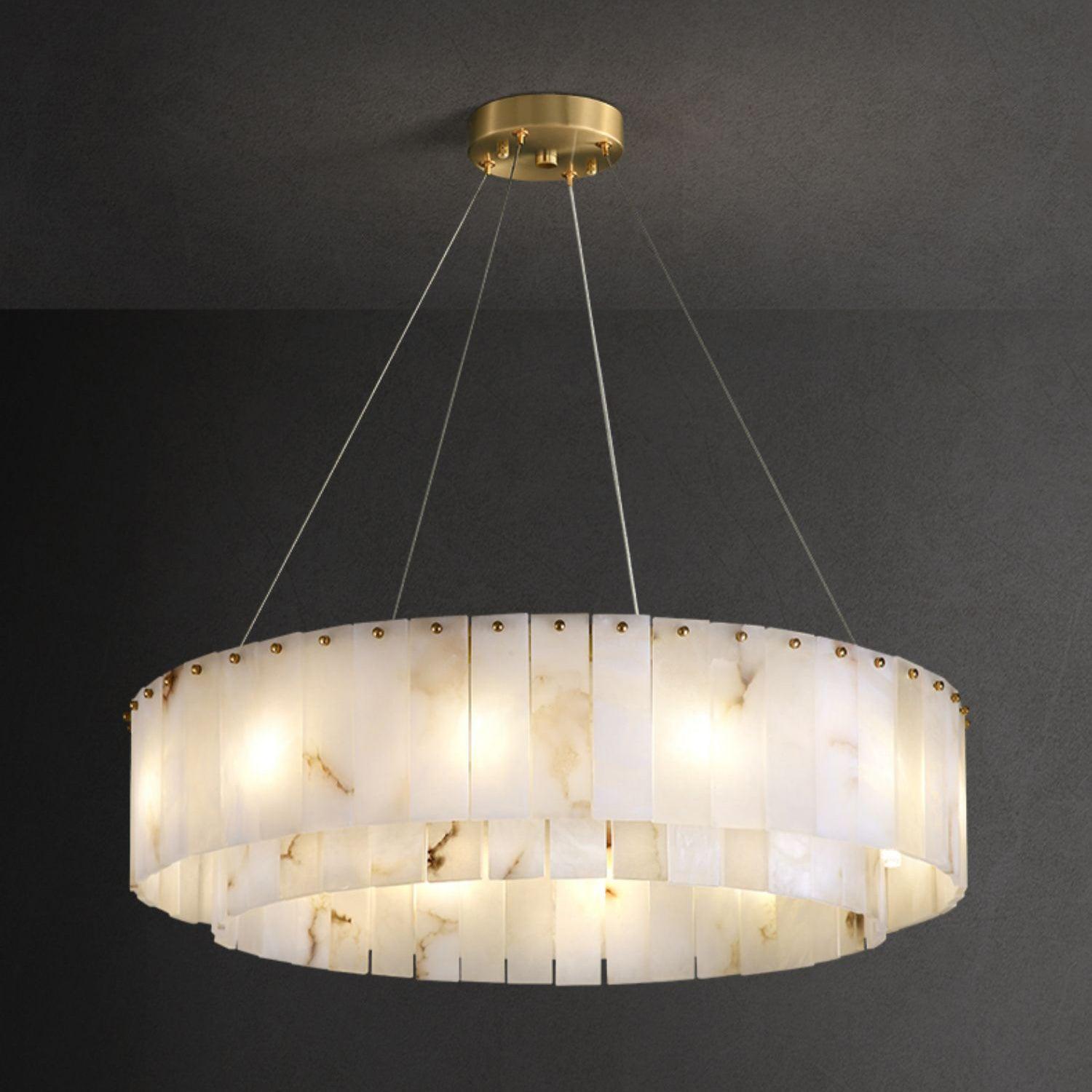 The Clérachic Rock chandelier seen level on grey, its two bands of stone panels lit.