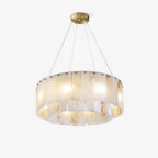 Clérachic Rock chandelier on white, hung on fine cables from a round brass canopy.