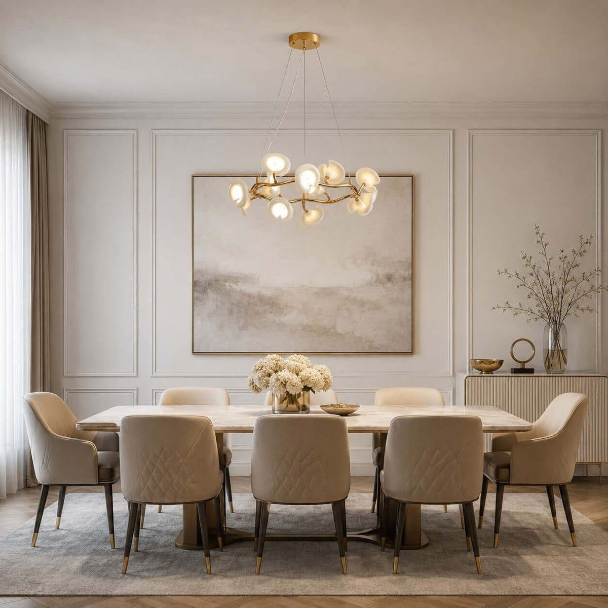 White ceramic petals on this Clérachic chandelier glow over a long dining table with quilted chairs, in front of a large soft painting.