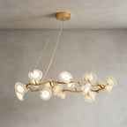 Side view of the round Clérachic chandelier, its ceramic petals clustered on a twisting gold ring and hung from three thin wires.
