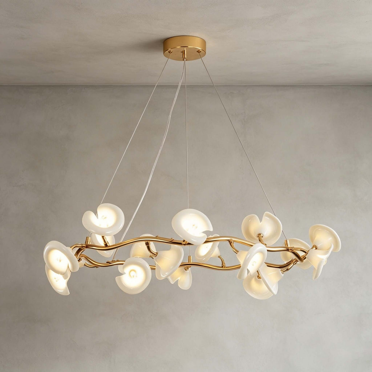 Side view of the round Clérachic chandelier, its ceramic petals clustered on a twisting gold ring and hung from three thin wires.