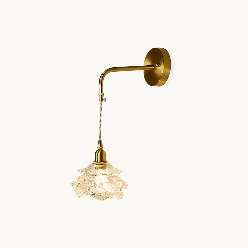 Brass wall plate and bent arm holding a twisted-cord drop to a rose-shaped glass shade, on this Clérachic wall light, on white.