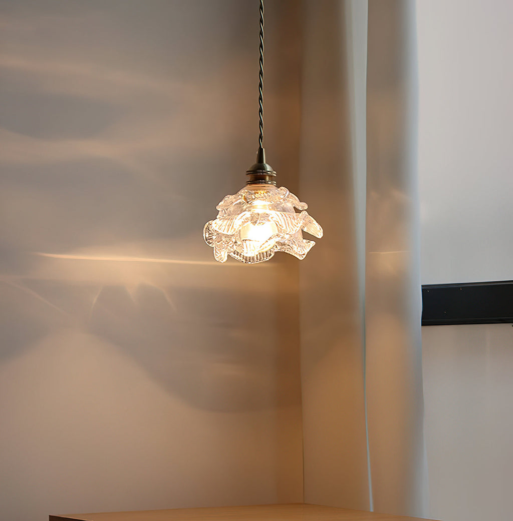 Soft light from the glass shade of this Clérachic wall light throws ripples of gold across a curtain and wall.