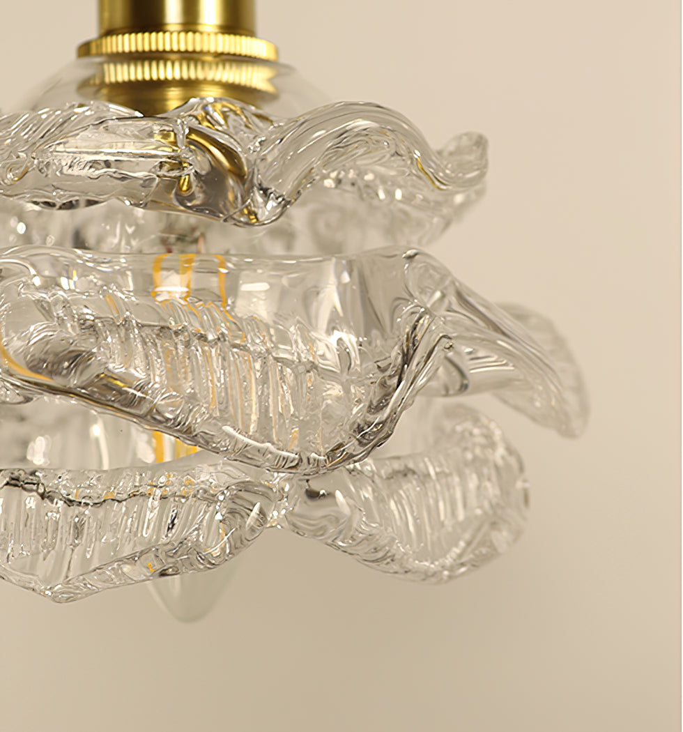 Close view of the knurled brass collar and the wavy glass edge of the shade on this Clérachic wall light.