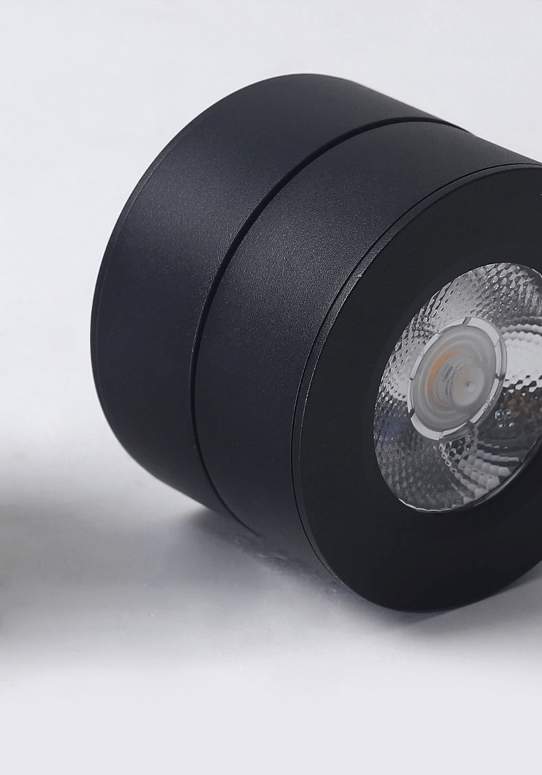 Close view of the black Clérachic spotlight, with its ribbed reflector and the split between its fixed base and its rotating head.