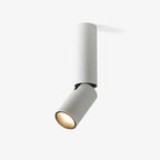 This Clérachic ceiling spotlight in white on a plain backdrop, a slim cylinder with an angled head and a warm light glowing from its lens.