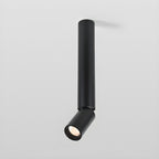 A black Clérachic ceiling spotlight with a long slim pole and an angled head, shown against a pale grey backdrop.