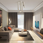 A cluster of white Clérachic spotlights in varied lengths hangs from the ceiling of a living room with a cream sofa.