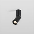 A short black Clérachic spotlight with an angled head, its lens showing a faceted reflector, on a light grey backdrop.