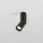 A short black Clérachic spotlight with an angled head, its lens showing a faceted reflector, on a light grey backdrop.