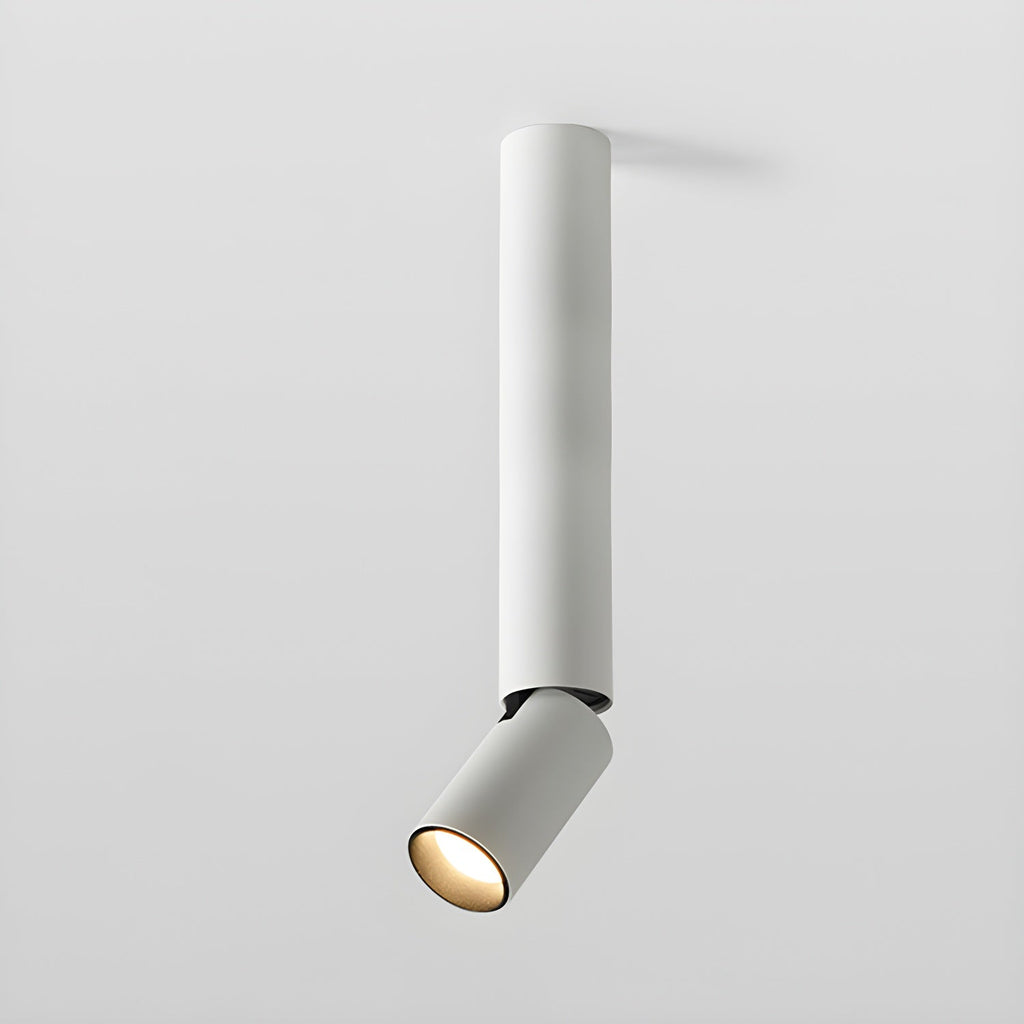White Clérachic spotlight with a long pole and a small angled head at the bottom, glowing warm.