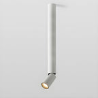 The longest white Clérachic spotlight pole, with a small tilted head at the bottom, on a pale backdrop.