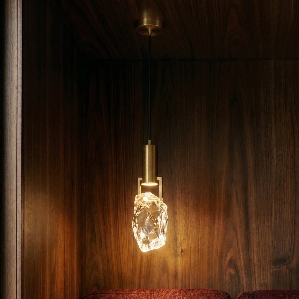 The Clérachic rough-cut crystal shade glows warmly against dark walnut paneling, its brass fittings catching light.