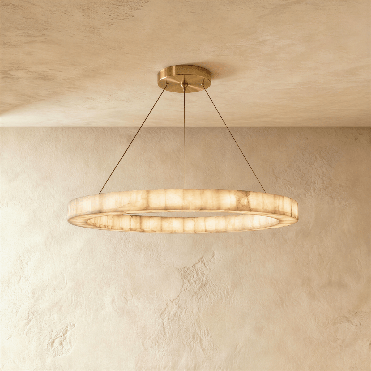 Clérachic single-ring alabaster chandelier, its glowing band suspended on cords from a round ceiling canopy.