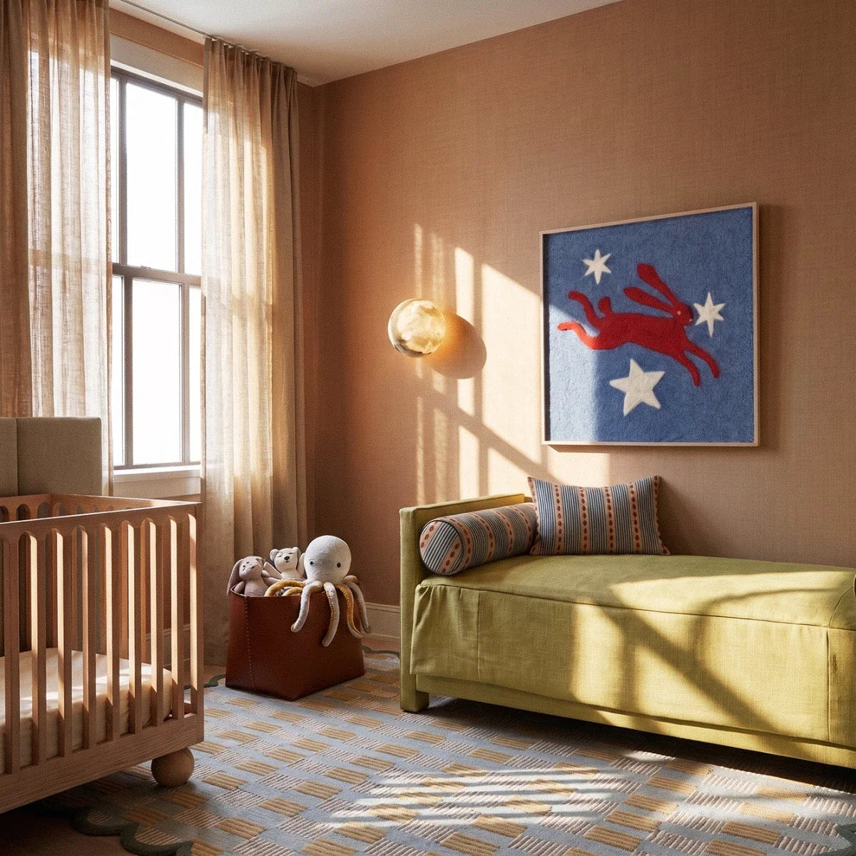 Clérachic alabaster wall lamp glowing on a warm wall in a nursery, beside a framed hare print and a green daybed.