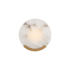 Clérachic alabaster wall sconce shown small on a white background, brass bracket beneath the warm-lit stone disc.
