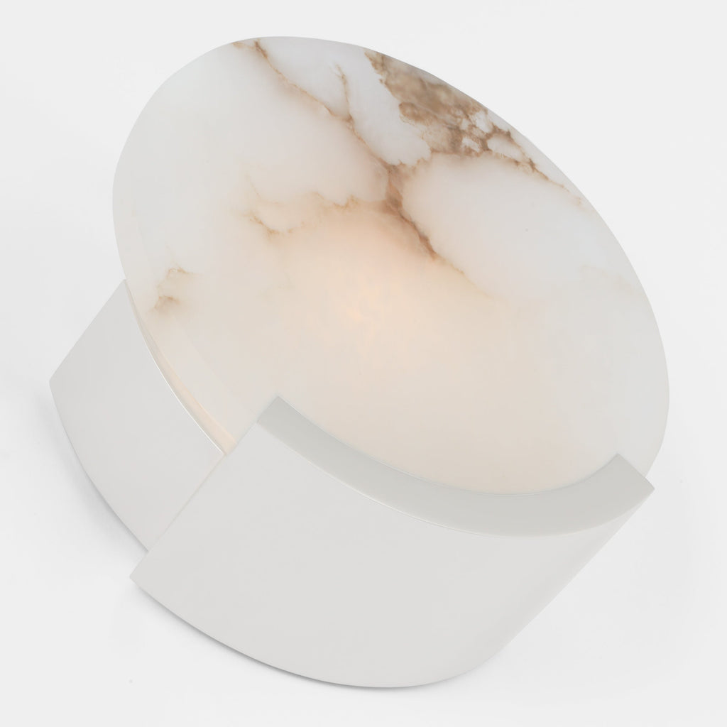 Clérachic alabaster sconce in chrome, tipped to show the mirrored bracket behind the warmly lit veined disc.