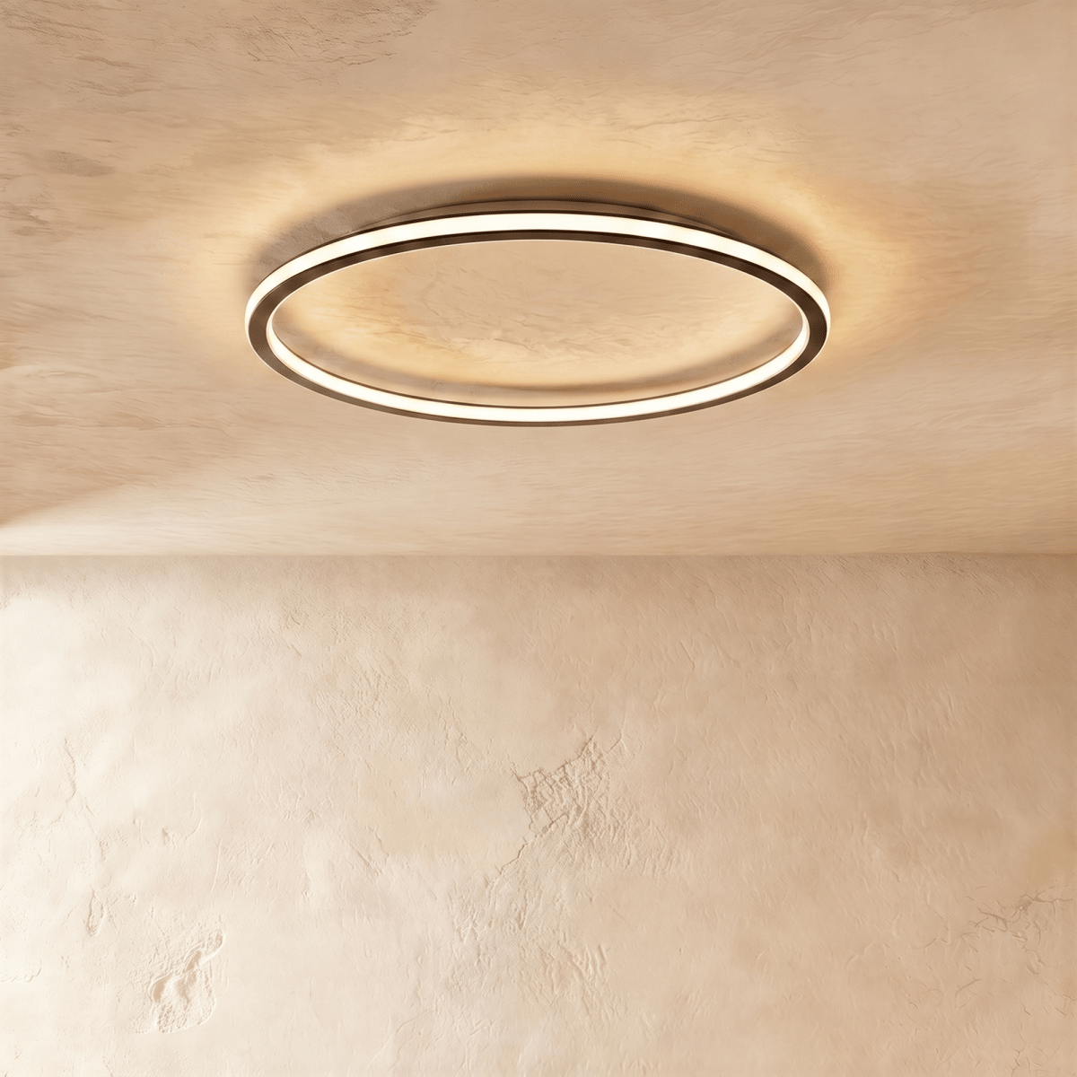Close angle on the Clérachic matte black ceiling ring, showing the slim frame and warm glow along its rim.