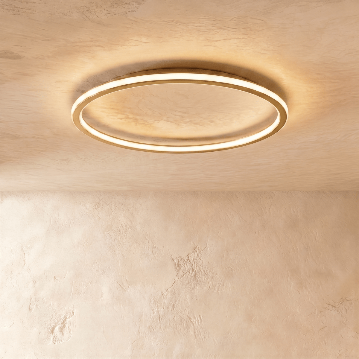 Close view of the Clérachic gold ceiling ring, showing the slim metal band and its warm LED edge glow.
