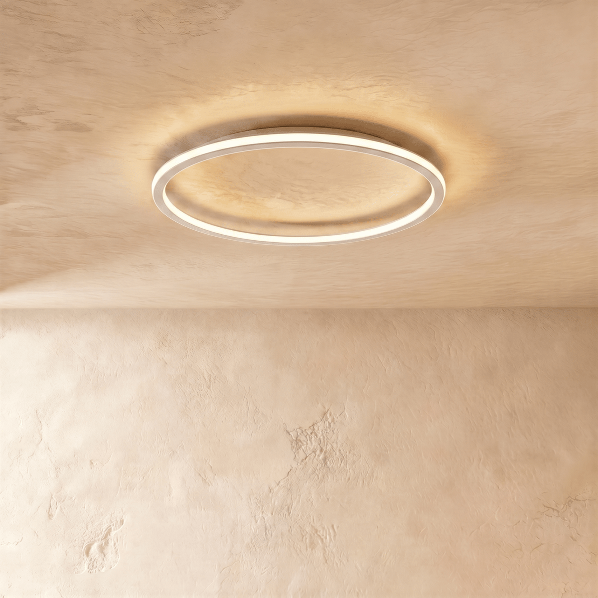 A side angle of the Clérachic white ceiling ring, showing its slim profile and soft warm glow along the rim.