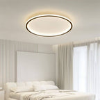 The Clérachic round ceiling light in matte black hangs above a bed with a striped headboard wall and sheer curtains.
