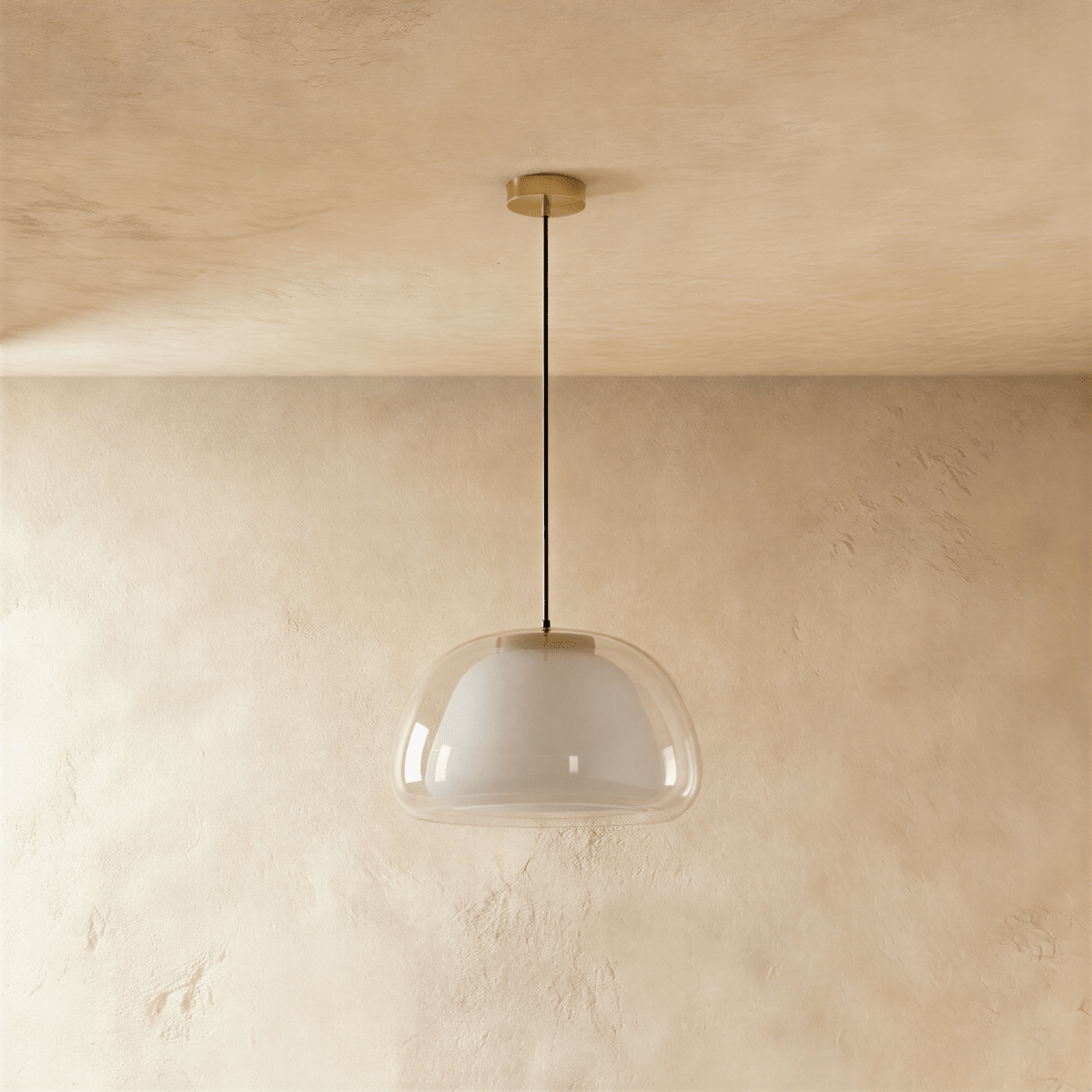 Clérachic pendant light, unlit, showing a clear glass outer shade over a white opal diffuser on a thin black cord and brass canopy.