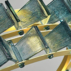 Close view of blue ribbed glass blades and the glass studs that fix them to the brass ring on this Clérachic chandelier.