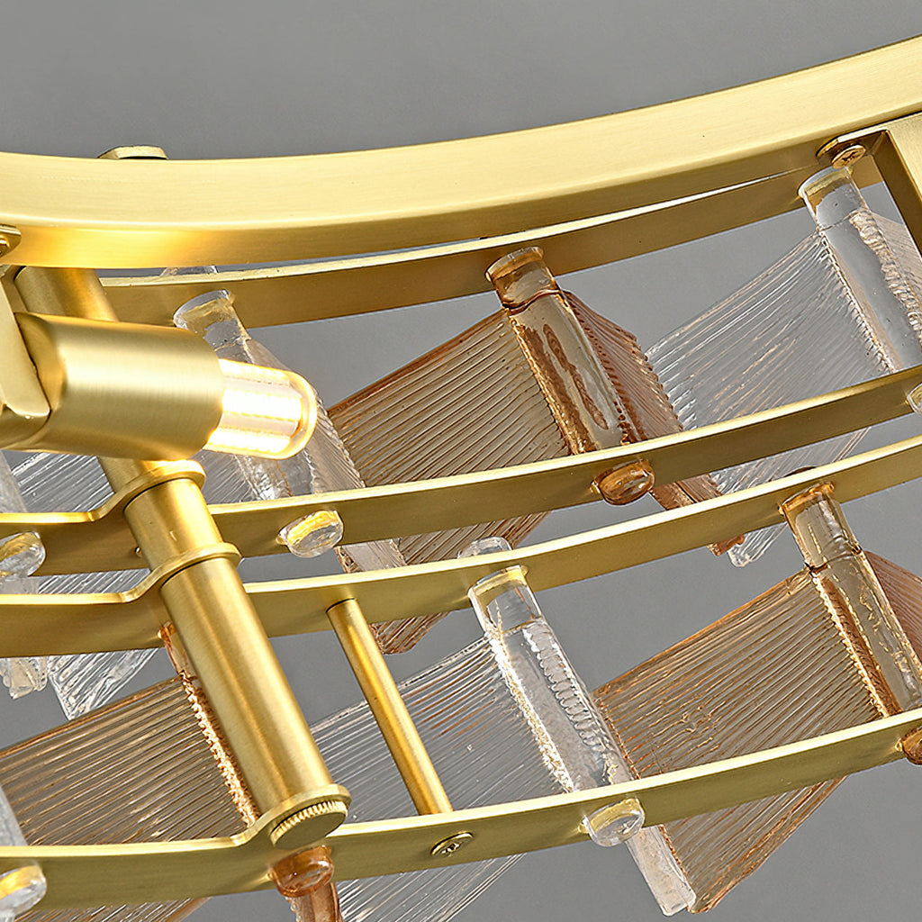 Close view of the brushed brass ring, rods and amber glass blades inside this Clérachic chandelier.