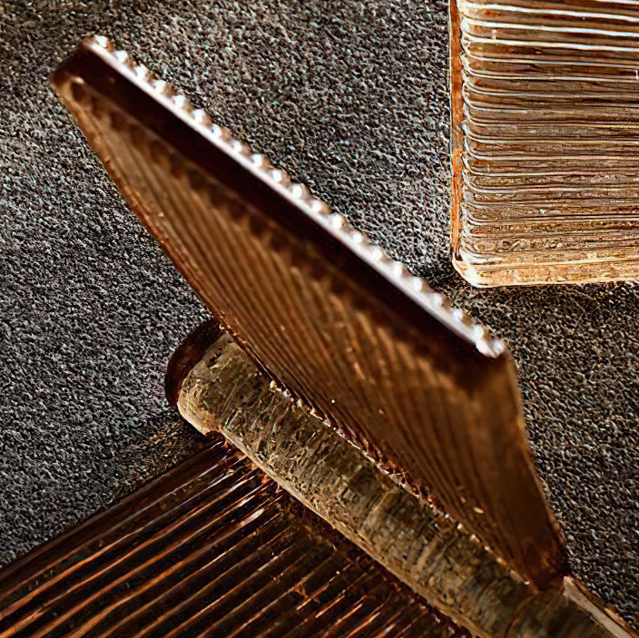 Close view of the fine ribbing along the edge of an amber glass blade from this Clérachic chandelier.