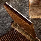 Close view of the fine ribbing along the edge of an amber glass blade from this Clérachic chandelier.