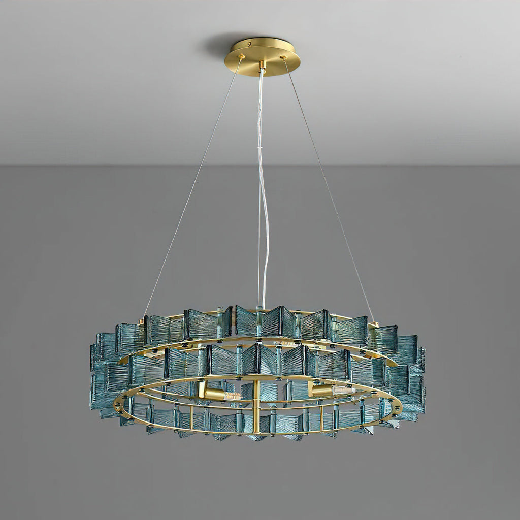 A blue Clérachic chandelier on a grey backdrop, hung from a round brass canopy on a single wire and two fine side cables.