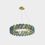 A blue Clérachic chandelier shown small on a pale backdrop, hanging from a brass canopy by three wires.
