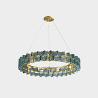 This Clérachic chandelier in blue glass on a light grey backdrop, hung from a gold canopy over a brass ring.