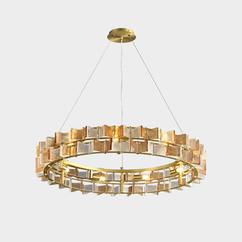 Straight-on view of an amber Clérachic chandelier on light grey, with a gold canopy and two tiers of glass.