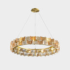 Straight-on view of an amber Clérachic chandelier on light grey, with a gold canopy and two tiers of glass.