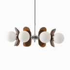 Clérachic chandelier with milky white globes and smoked brown acrylic petals on a polished chrome stem, white backdrop