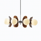 Clérachic chandelier with cream glass globes among tinted brown acrylic petals, hung from a slim chrome rod