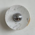 Near-white marble with a few faint grey and gold veins forms this Clérachic wall light, around a chrome dome.